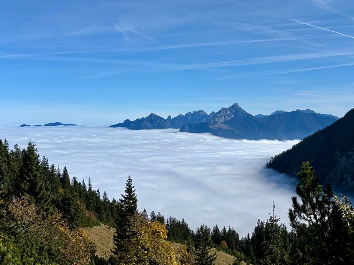 Stunning mountain landscape above a sea of clouds in clear daylight.