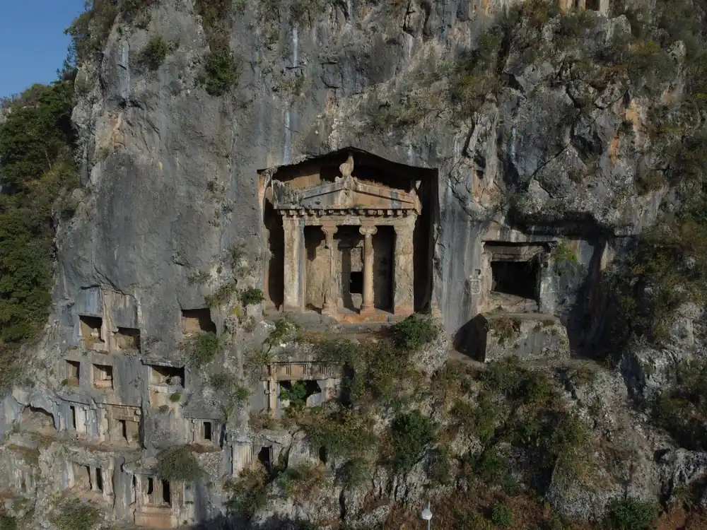 Ancient rock-cut tombs of Amyntas nestled in a rocky mountainside in Fethiye, Turkey.