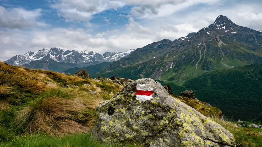 Beautiful view of snowcapped mountains and hiking trail in Scanfs, Switzerland.