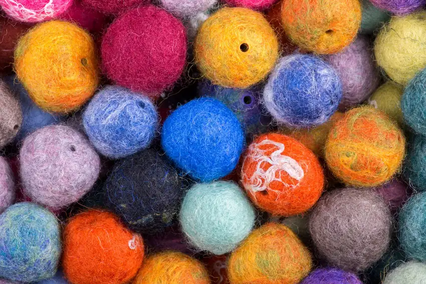 A vibrant collection of colorful wool felt balls, perfect for crafting and decoration.